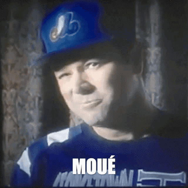 a man wearing a blue hat and a blue shirt that says moue on it