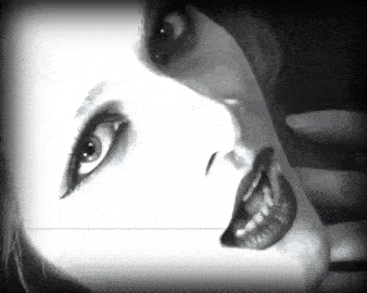 a black and white photo of a woman 's face with her mouth open