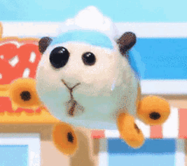 a stuffed animal with a bandana on its head is flying in the air