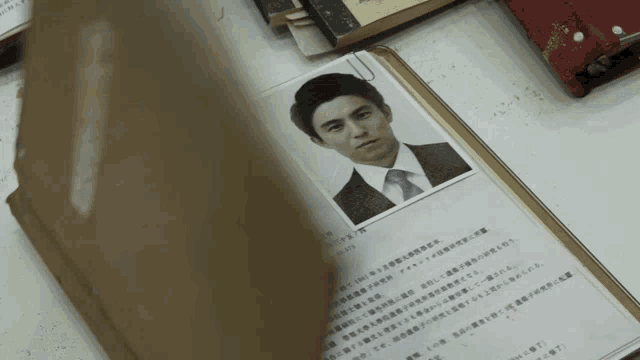 a book is open to a page with a picture of a man in a suit