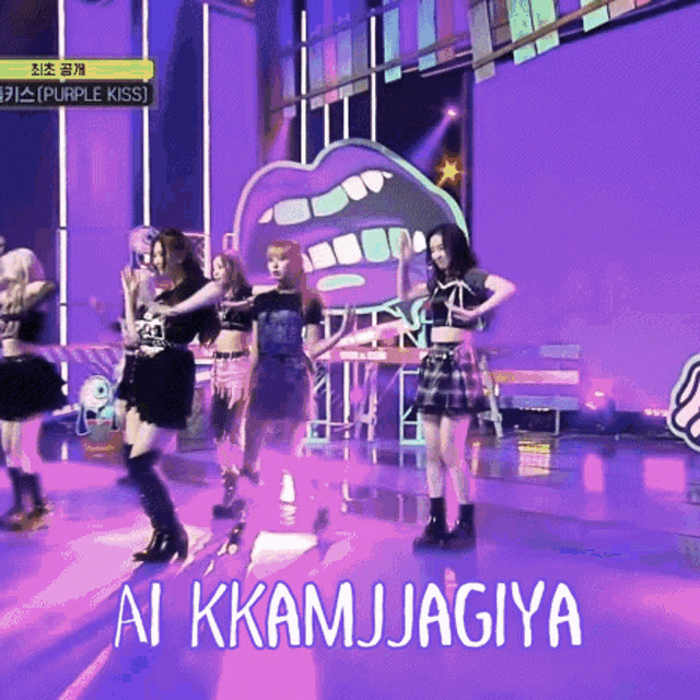 a group of girls are dancing on a stage with ai kkam jagiya written on the bottom