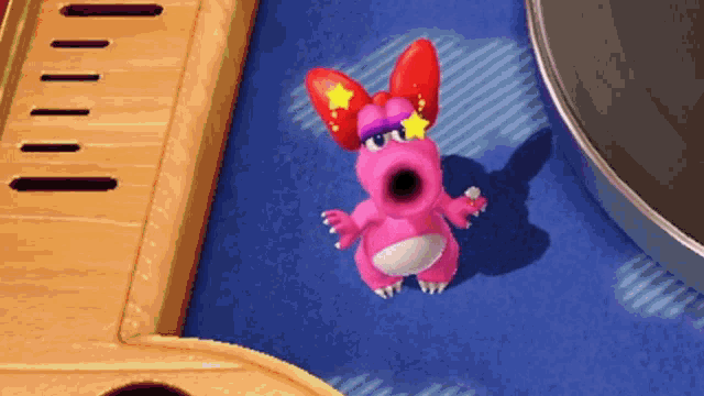 a pink cartoon character with red ears and a star in her eyes