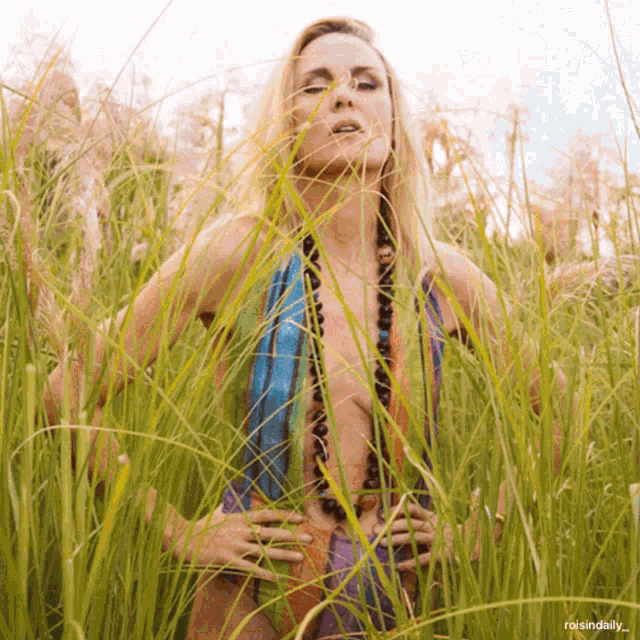 a woman standing in a field of tall grass with a caption that says roisindialy
