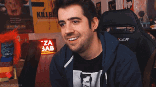 a man giving a thumbs up in front of a sign that says kill bill