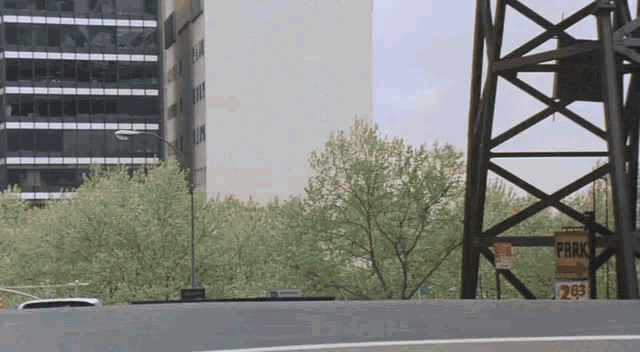 a sign that says park is on the side of a bridge