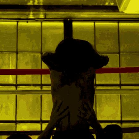 a man and a woman are in a boxing ring and the woman is naked