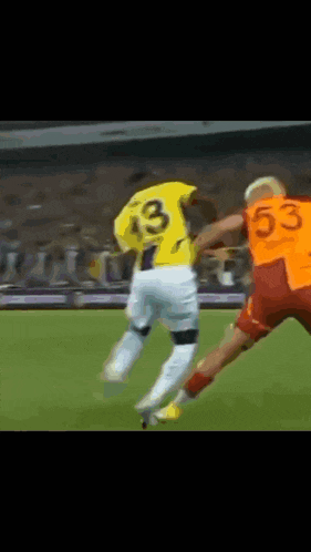 a soccer player wearing a yellow jersey with the number 33 on it