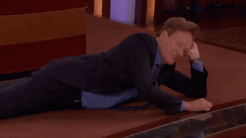 Going To The Happy Place GIF - Conan O Brien Get Down Laying Down GIFs