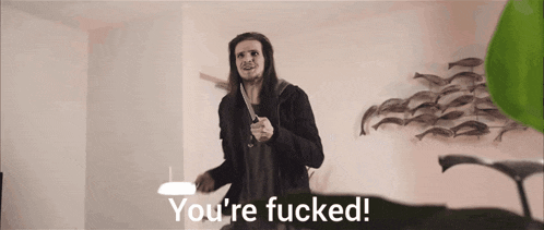 a man with long hair is holding a knife and the words you 're fucked are above him