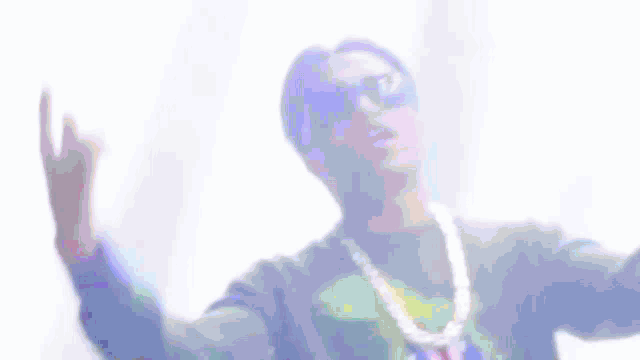 a blurry picture of a man wearing sunglasses and a chain .
