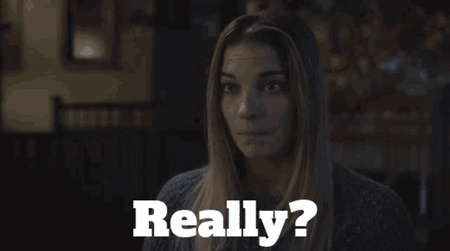 a woman in a dark room with the words " really " behind her