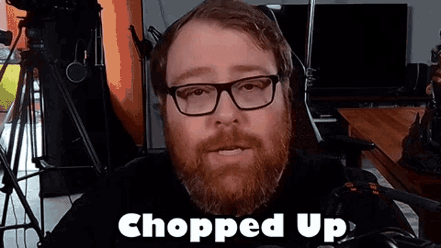 a man with glasses and a beard has the word chopped up above him