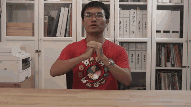 a man wearing a red shirt that says mr. keith