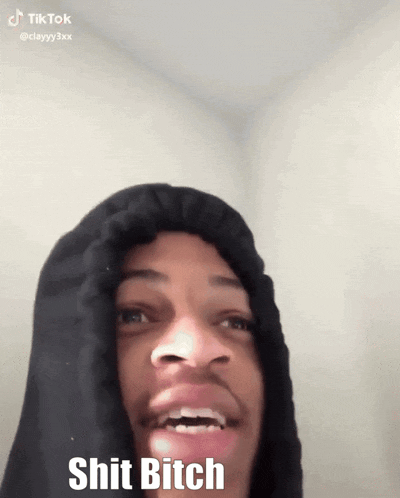 a man wearing a black hoodie with the words shit bitch written on it