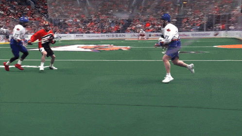 a lacrosse game is being played in a stadium with a referee wearing a jersey with the number 1 on it