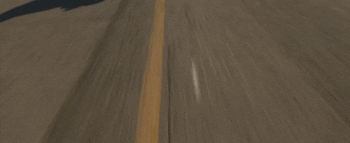 a group of men are riding motorcycles down a highway