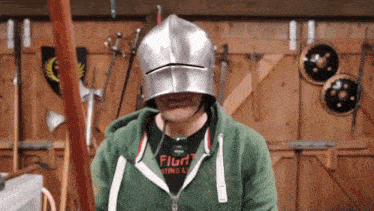 a man wearing a helmet and a shirt that says " fight " on it