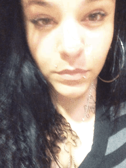 a close up of a woman 's face with a tattoo on her neck that says " i love you "