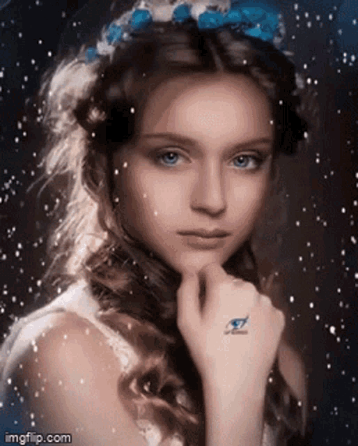 a girl with flowers in her hair has a tattoo of an eye on her wrist .
