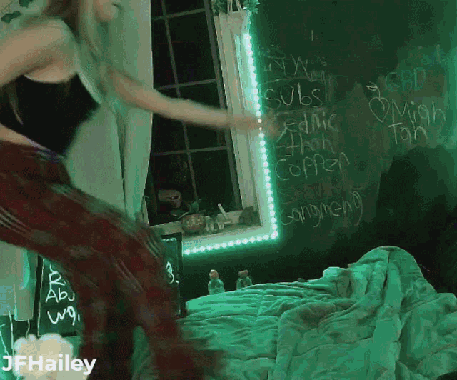 a woman is dancing in front of a chalkboard with the name hailey on it