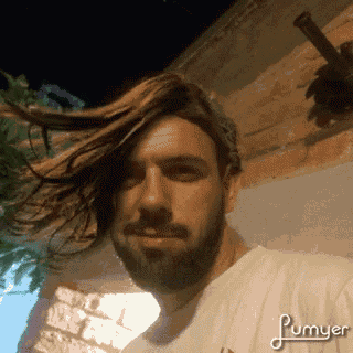 a man with a beard is wearing a white shirt that says plumyer on it