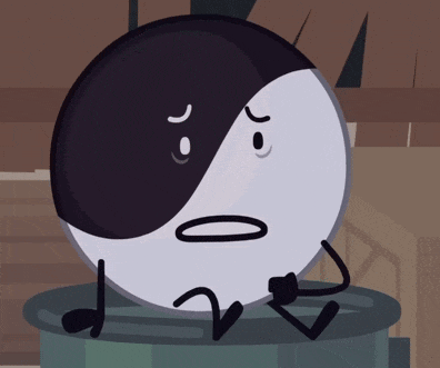 a black and white circle with a sad face is sitting on a trashcan