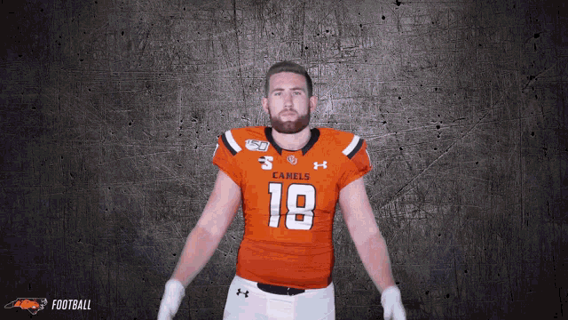 a man wearing an orange jersey with the number 18