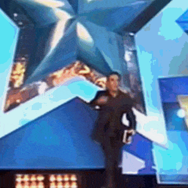 a blurry picture of a man standing in front of a large star