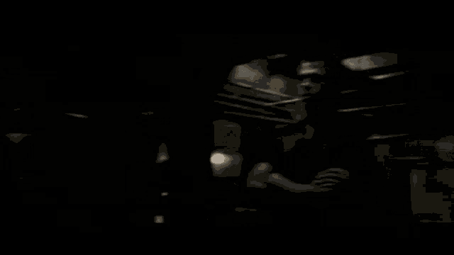 a man with his arms crossed is standing in a dark room with the words welcome to timecode below him