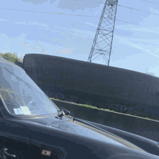 a black car with a red sticker on the hood that says ' a ' on it