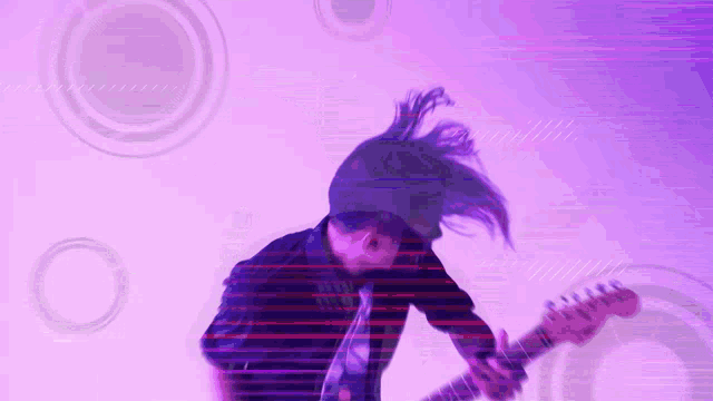 a man with long hair is playing a guitar with a purple background