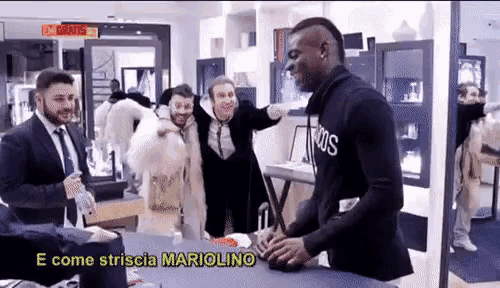 a group of men standing around a table with the words e come striscia mariolino written on the bottom