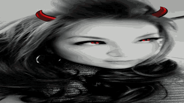 a black and white photo of a woman with red horns on her head