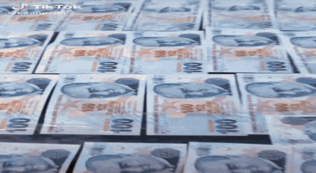 a bunch of 100 bills on a table