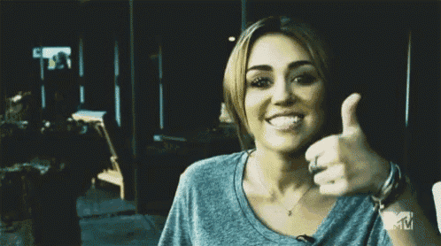 a woman giving a thumbs up with a mtv logo in the background