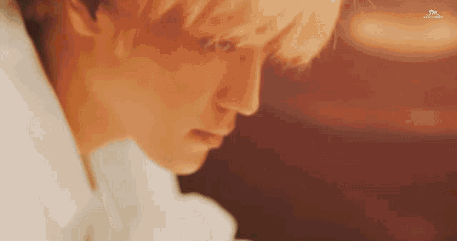 a close up of a person 's face with a light shining on it .