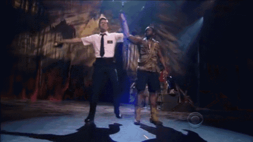 a man in a white shirt and tie is dancing with another man