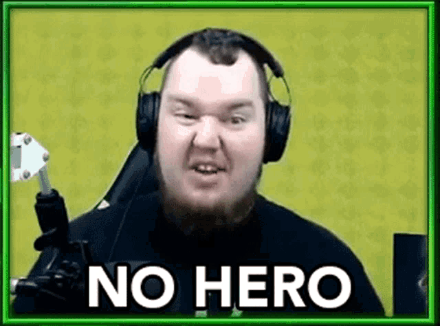 a man wearing headphones and a microphone is making a funny face and says `` no hero '' .