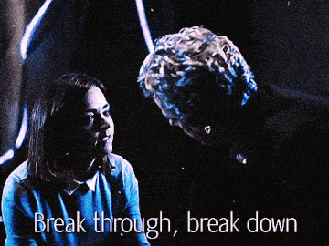 a man and a woman looking at each other with the words break through break down