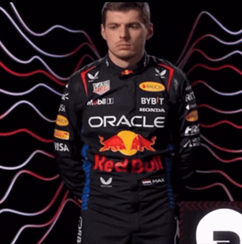 a man wearing a red bull racing uniform with oracle written on it
