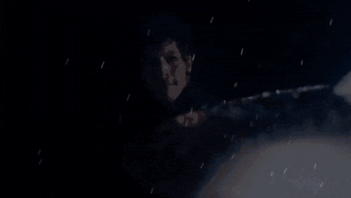 a close up of a person 's face in a dark room .