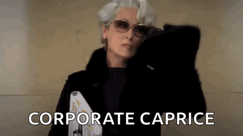 a woman wearing sunglasses and a fur coat is holding a magazine and the words `` corporate caprice '' .