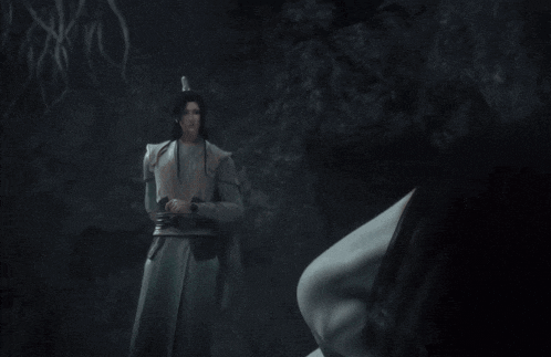 a man in a white robe stands next to another man