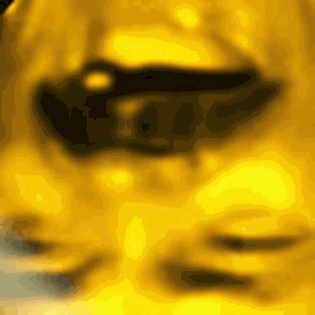a close up of a person 's face with a yellow background and sunglasses on .