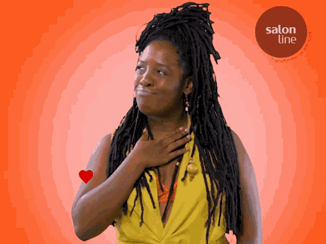 a woman with dreadlocks is smiling in front of a salon line advertisement