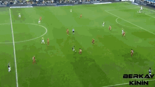 a soccer game is being played on a field sponsored by berkay kinin