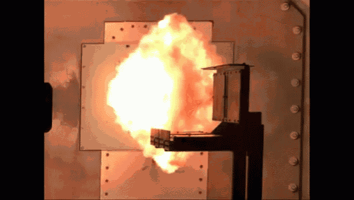 a large explosion is taking place in a metal box .