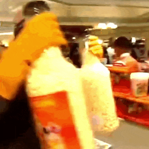 a person is holding a bag of popcorn in their hands