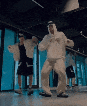 a man wearing a white hoodie with the word s on it