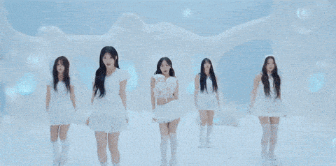 a group of young women in white dresses are dancing